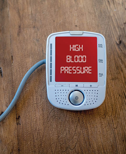 Medical device show high blood pressure on monitor. Digital measuring of health. Text on red varning display.