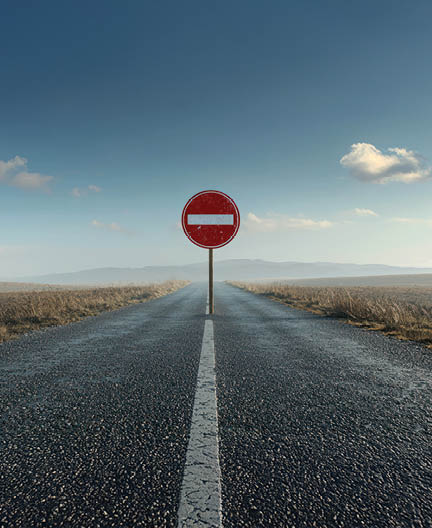 a road with a significant roadblock or detour sign, symbolizing challenges and obstacles in a journey.