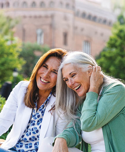 Beautiful senior women bonding outdoors in the city - Attractive cheerful mature female friends having fun, shopping and bonding, concepts about elderly lifestyle